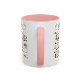 A white ceramic mug with a pink interior and a pink handle, featuring a printed coffee-themed illustration on the side.