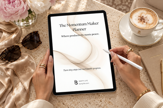 The Momentum Maker Planner on an iPad with Apple Pencil on a travertine table