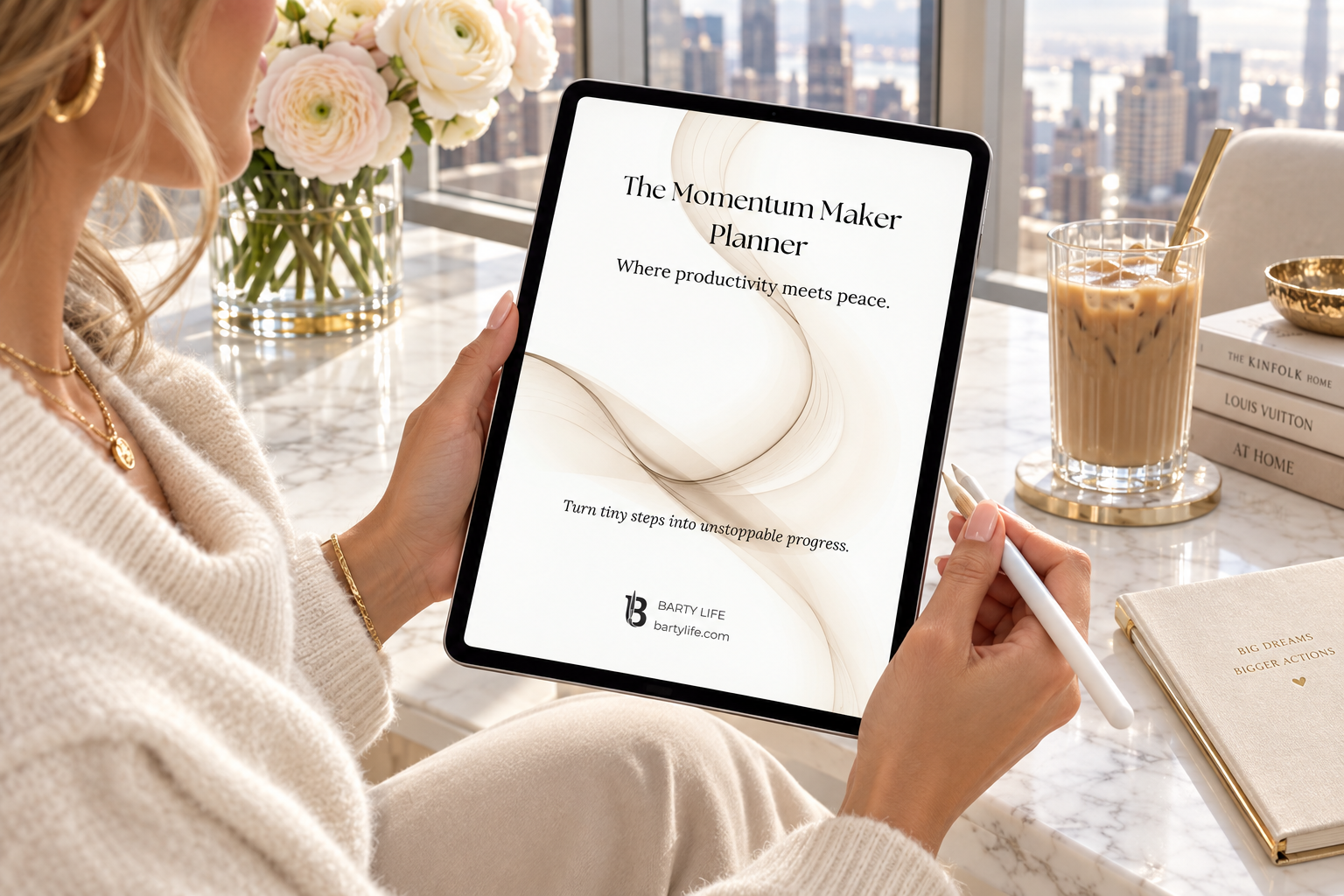 The Momentum Maker Planner on an iPad held by a woman at a marble desk in a luxury office