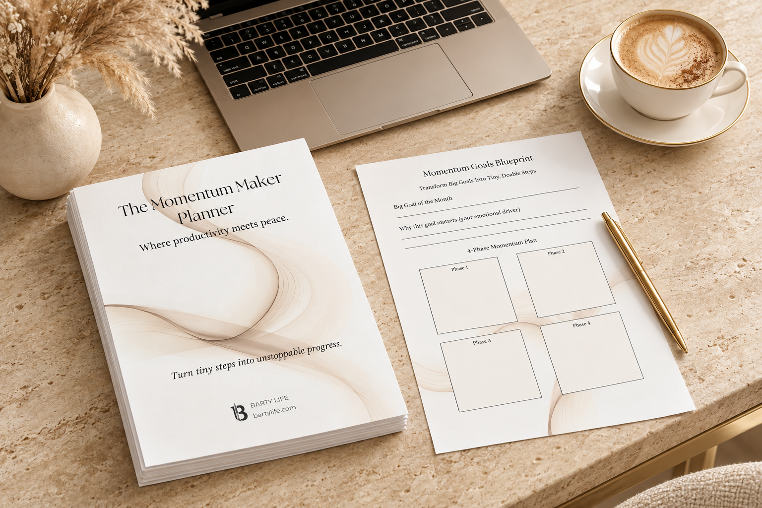 Printed Momentum Maker Planner cover and Momentum Goals Blueprint page on a travertine desk