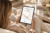 Woman using The Momentum Maker digital planner on an iPad in a luxury living room