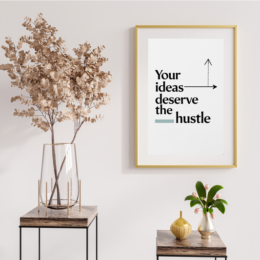 Motivational wall art print with black text 'Your ideas deserve the hustle' and an arrow graphic, set against a minimalist white background.